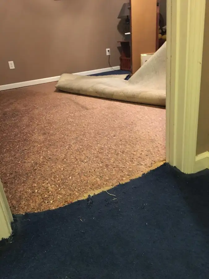 Carpet pad removal revealing water damage during Water Mitigation Services in Quartz Hill